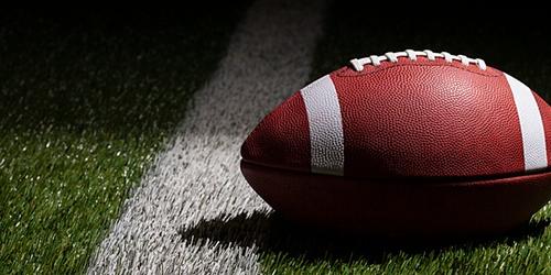 Ball used in American football lying on the pitch